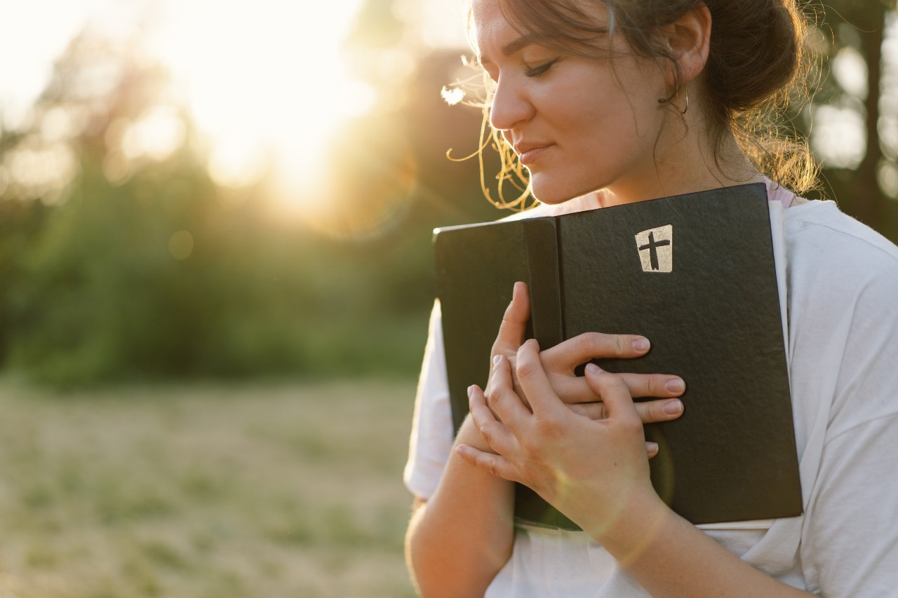 christian-woman-holds-bible-in-her-hands christian-woman-holds-bible-in-her-hands